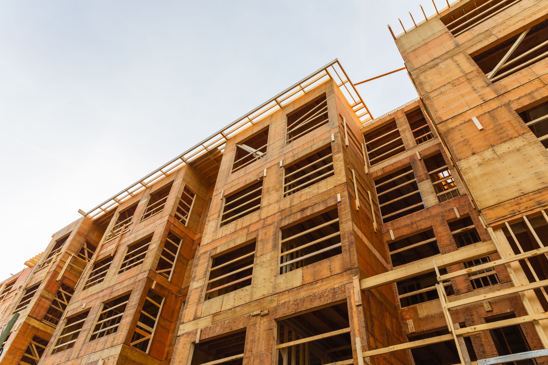 New residential construction home framing against a blue sky. Roofing construction. Wooden construction